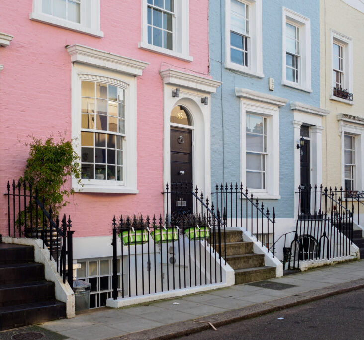 Coloured painted house terraces in London, 2017. Squared format. party wall