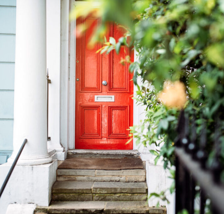 Beautiful red door in a white house facade in Notting Hill